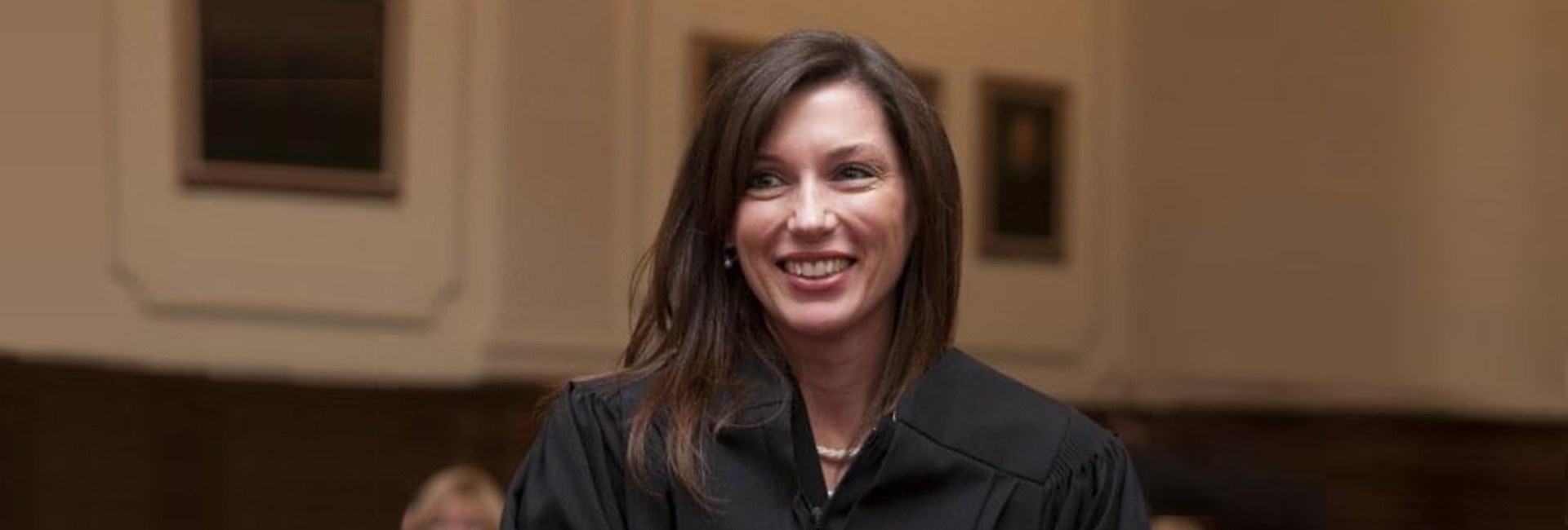 Banner image of Cathleen Rebar. Cathleen is wearing her judge robes.