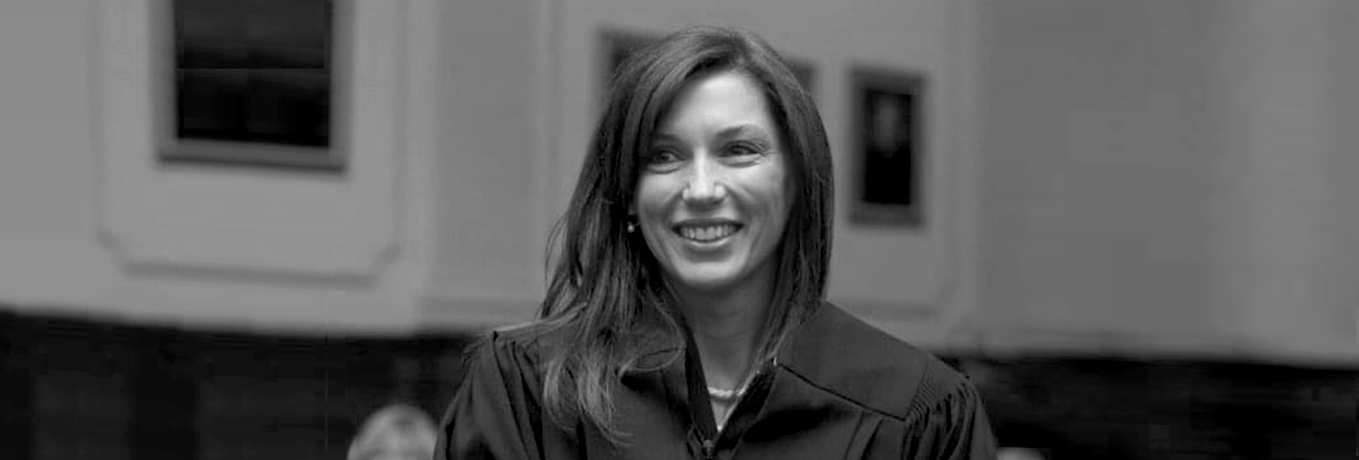 Banner image of Cathleen Rebar in black and white. Cathleen is wearing her judge robes.